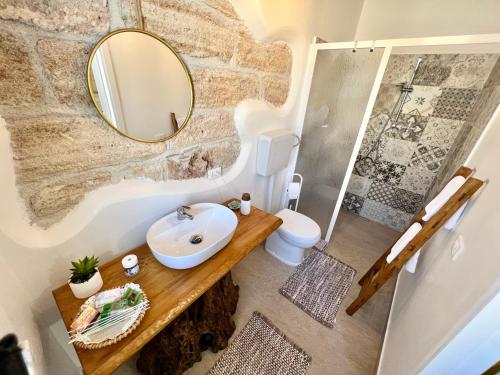 a bathroom with a sink and a mirror at da Mumminedda in Cinisi