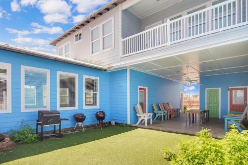 a blue house with a porch and a patio at Beach Club 1 in Port Aransas