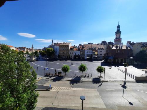 an empty street in a town with a clock tower at Belváros Apartmanház Sopron in Sopron