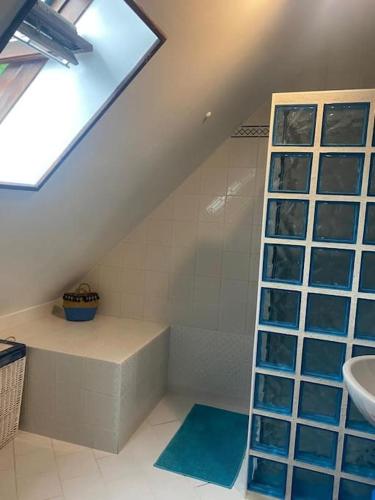 une salle de bain avec une douche et un lavabo et une fenêtre dans l'établissement Gîte Les Aubins - Bord de Mer - Cotentin, à Bretteville-sur-Ay