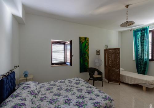a bedroom with a bed and a chair in it at B&B Mesa Gaia - Irpinia in Teora