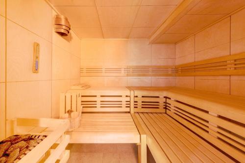 a sauna with wooden benches in a room at Hotel Parkresidenz Christian VIII in Archsum