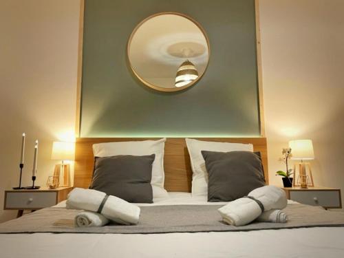 a bedroom with a large mirror above a bed at Le GREEN'SPA - DIJON - SPA-jardin-parking privé in Longvic