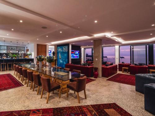 un comedor con mesa y sillas y un bar en Boutique Ocean Views - incorporating Wendy's, en Hermanus