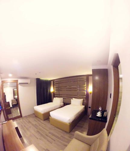 Кровать или кровати в номере El Vistra Hotel Angeles