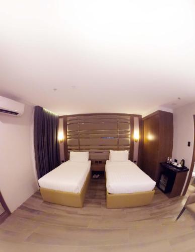 Кровать или кровати в номере El Vistra Hotel Angeles