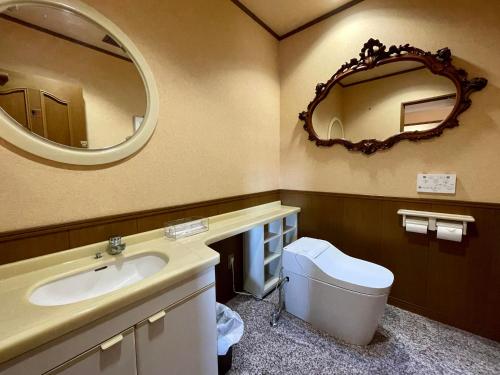 a bathroom with a sink and a mirror at Hitachinaka Villa DAN - ひたちなか 暖 - in Hitachinaka