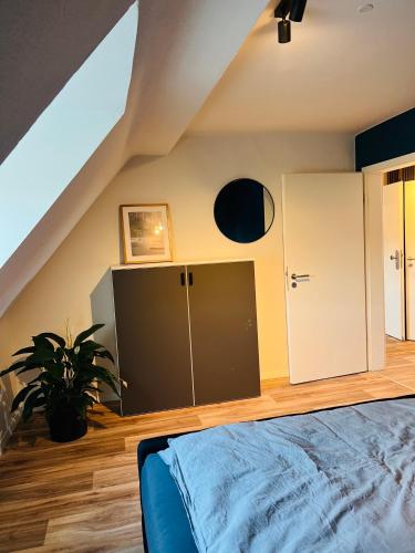 an attic bedroom with a bed and a closet at Himmlische Weite 3 in Schweinfurt