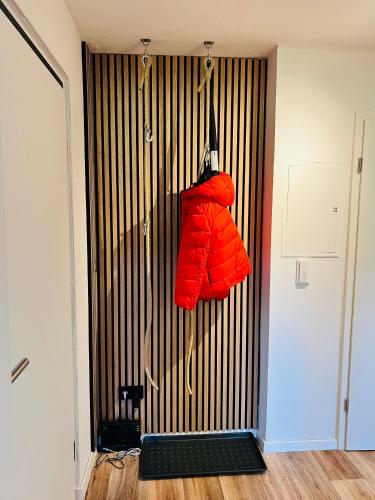 a red jacket hanging on a wall in a room at Himmlische Weite 3 in Schweinfurt