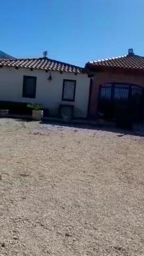 a house with a dirt yard in front of it at Camera Tina in Castellammare del Golfo