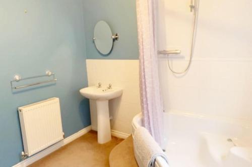 a bathroom with a sink and a toilet and a shower at SPACIOUS DETACHED 5 Bedroom4 Bathroom WIFI Parking in Newcastle under Lyme