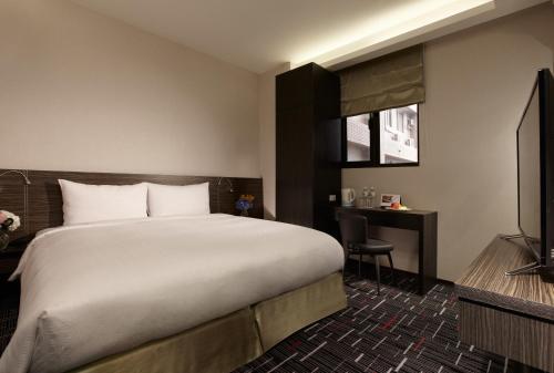 Postel nebo postele na pokoji v ubytování Capital Hotel SongShan