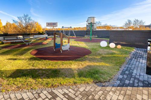 a park with a playground with a swing at 15 korruse premium katusekorter in Tallinn