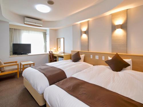 Postel nebo postele na pokoji v ubytování Hotel Palm Spring
