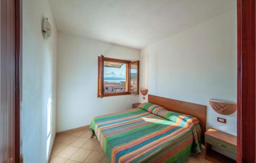 a small bedroom with a bed and a window at 1 Bedroom Beautiful Apartment In Isola Rossa in Isola Rossa