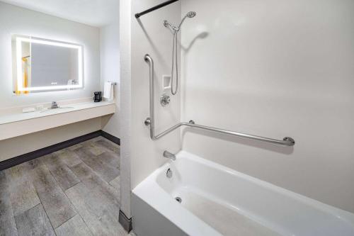 a white bathroom with a tub and a sink at La Quinta Inn by Wyndham Laredo I-35 in Laredo