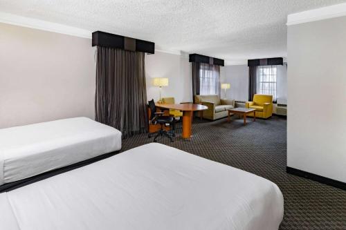 a hotel room with two beds and a table at La Quinta Inn by Wyndham Laredo I-35 in Laredo
