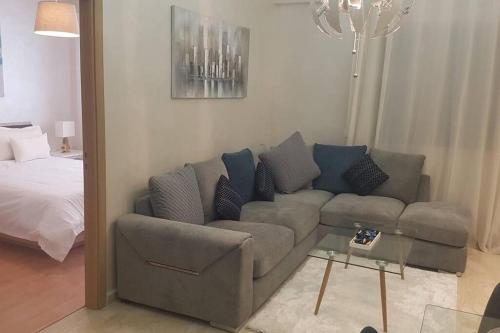 a living room with a couch and a bed at A 200m de la Plage, du Haut Standing au coeur du Parc in Mohammedia