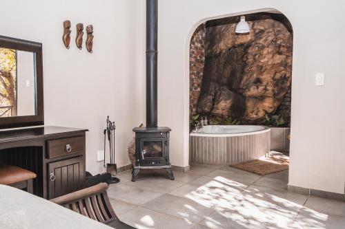 a bathroom with a fireplace and a bath tub at Thabela Thabeng in Parys