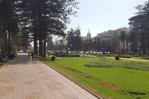 a sidewalk in a park with trees and grass at A 200m de la Plage, du Haut Standing au coeur du Parc in Mohammedia
