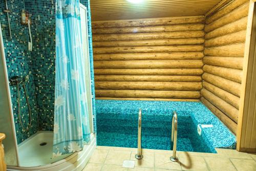 a bathroom with a swimming pool and a shower at V&P HOTEL & Restaurant in Khust