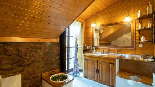 a bathroom with a sink and a mirror at Molino Rodete Jimera de Libar by Ruralidays in Jimera de Líbar