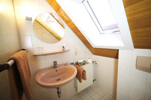 a bathroom with a sink and a skylight at Gasthof Hirsch in Schollbrunn