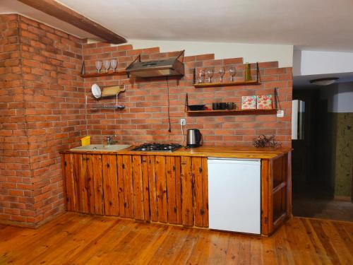 a kitchen with a brick wall and a counter top at Agroturystyka UL in Nowe Worowo