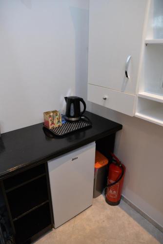 a kitchen with a black counter with a tea kettle on it at Room Marsonia in Slavonski Brod