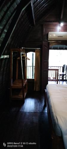 a room with a bed and a ladder in a house at D'kailash Retreat in Singaraja