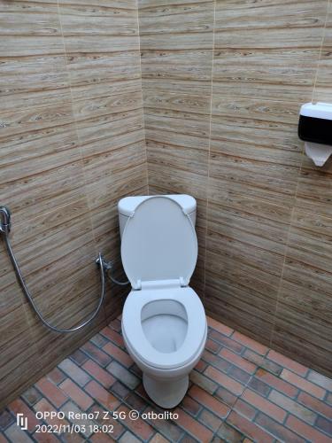 a bathroom with a white toilet in a room at D'kailash Retreat in Singaraja