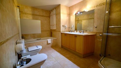 a bathroom with a toilet and a sink and a shower at Marbella Beach Resort at Club Playa Real in Marbella