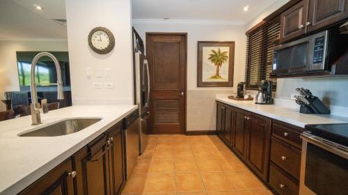 a kitchen with a sink and a counter top at Boungainvillea 7105 Luxury Apartment - Reserva Conchal in Playa Conchal