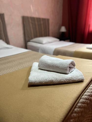 a towel on a bed in a hotel room at Hotel Albatros in Batumi