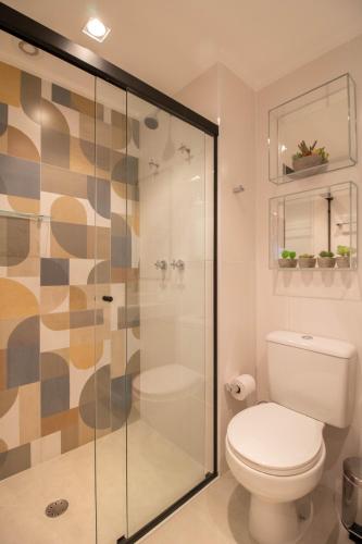 a bathroom with a toilet and a glass shower at Unique Studio - GRU 1803 in Guarulhos