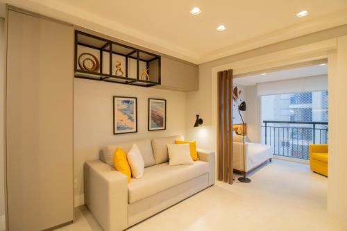 a living room with a couch and a balcony at Unique Studio - GRU 1803 in Guarulhos