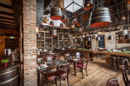 a restaurant with tables and chairs in a room at 4-Sterne Erlebnishotel El Andaluz, Europa-Park Erlebnis-Resort in Rust