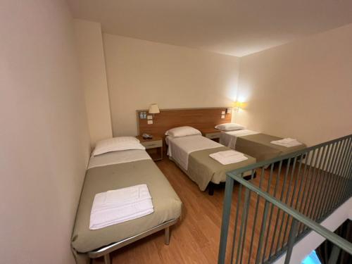 a hospital room with two beds and a balcony at Domus Stella Maris - Casa per Ferie in Ancona