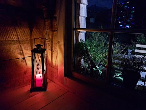 a lantern sitting in a room next to a window at Hüttenzauber in Taxenbach