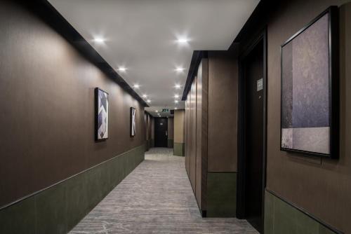 a corridor of a hallway with brown walls and a corridorngthngthngth at Hotel Holiday International in Sharjah