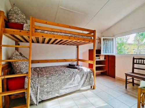 a bedroom with two bunk beds and a chair at La Maryse de Cassis in Cassis