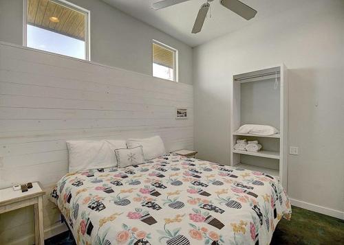 a bedroom with a large bed and a window at Beach Club 2 in Port Aransas