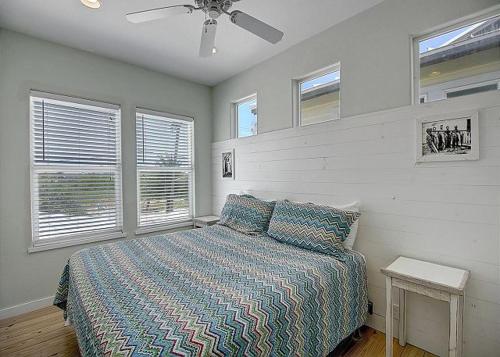 a bedroom with a bed and a ceiling fan at Beach Club 2 in Port Aransas