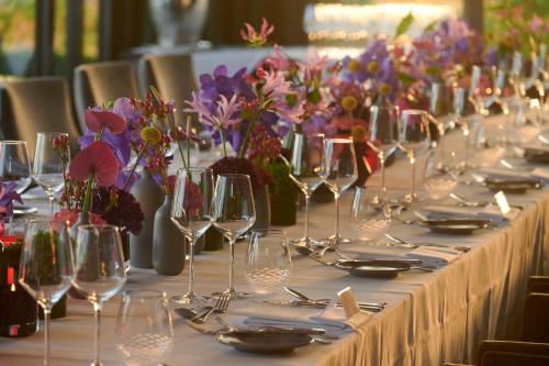 a long table with wine glasses and flowers on it at Burg & Gästehaus by Schwarzenstein in Geisenheim
