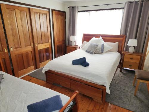 1 dormitorio con cama y ventana en A Holiday Home for Every Season en Bateau Bay