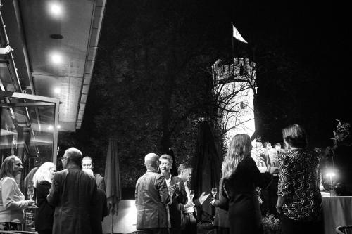 a group of people standing in a crowd at a party at Burg & Gästehaus by Schwarzenstein in Geisenheim