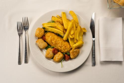 a plate of food with french fries and chicken nuggets at Emotional Grand Motel in Fontaneto dʼAgogna