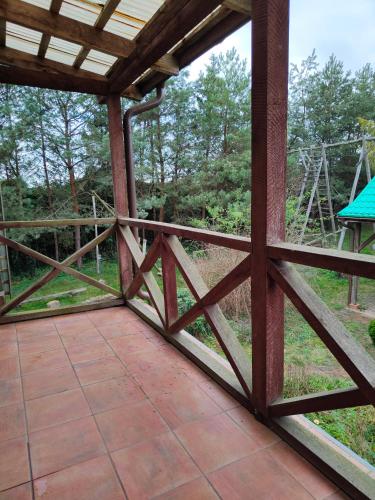 a view from the porch of a house with a wooden railing at Agroturystyka UL in Nowe Worowo