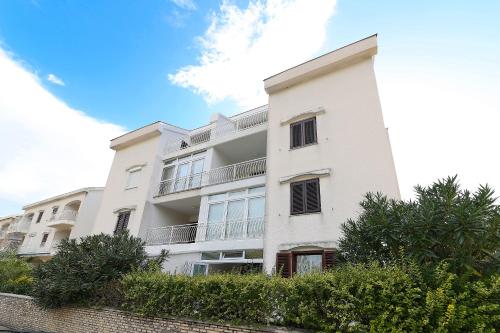 a white building with balconies on the side of it at Jadranovo Dunja in Jadranovo
