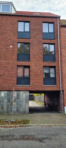 a red brick building with windows on a street at Gormsgade 96. 3. dør 12 (id.033) in Esbjerg